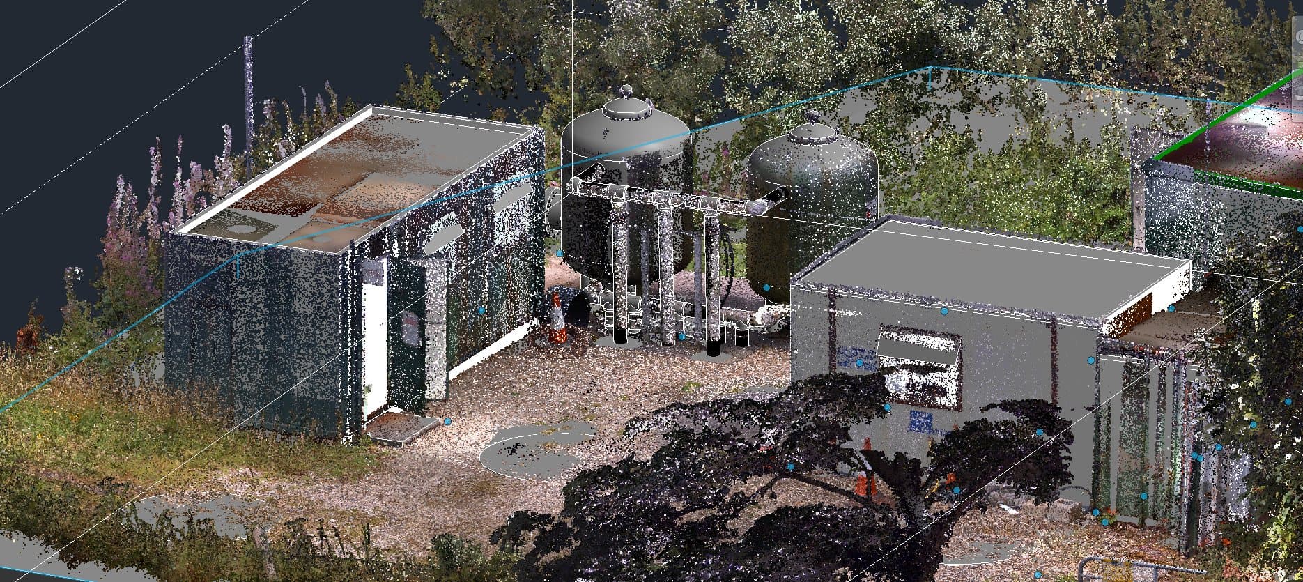 Full-colour point cloud of a water treatment plant site: kiosks, filter tanks and pipework among trees
