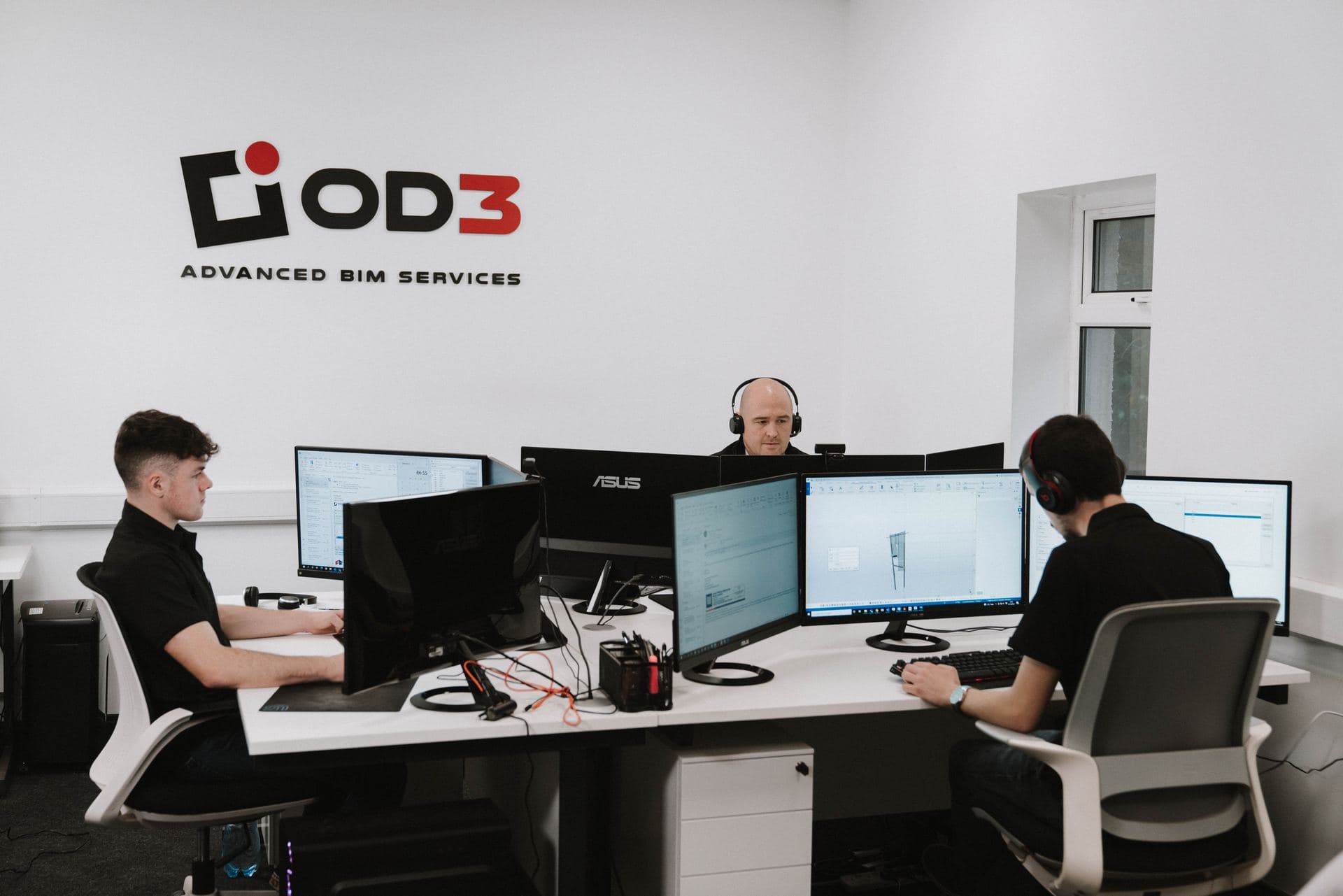 The OD3 studio — engineers at multi-monitor Tekla workstations beneath the OD3 logo