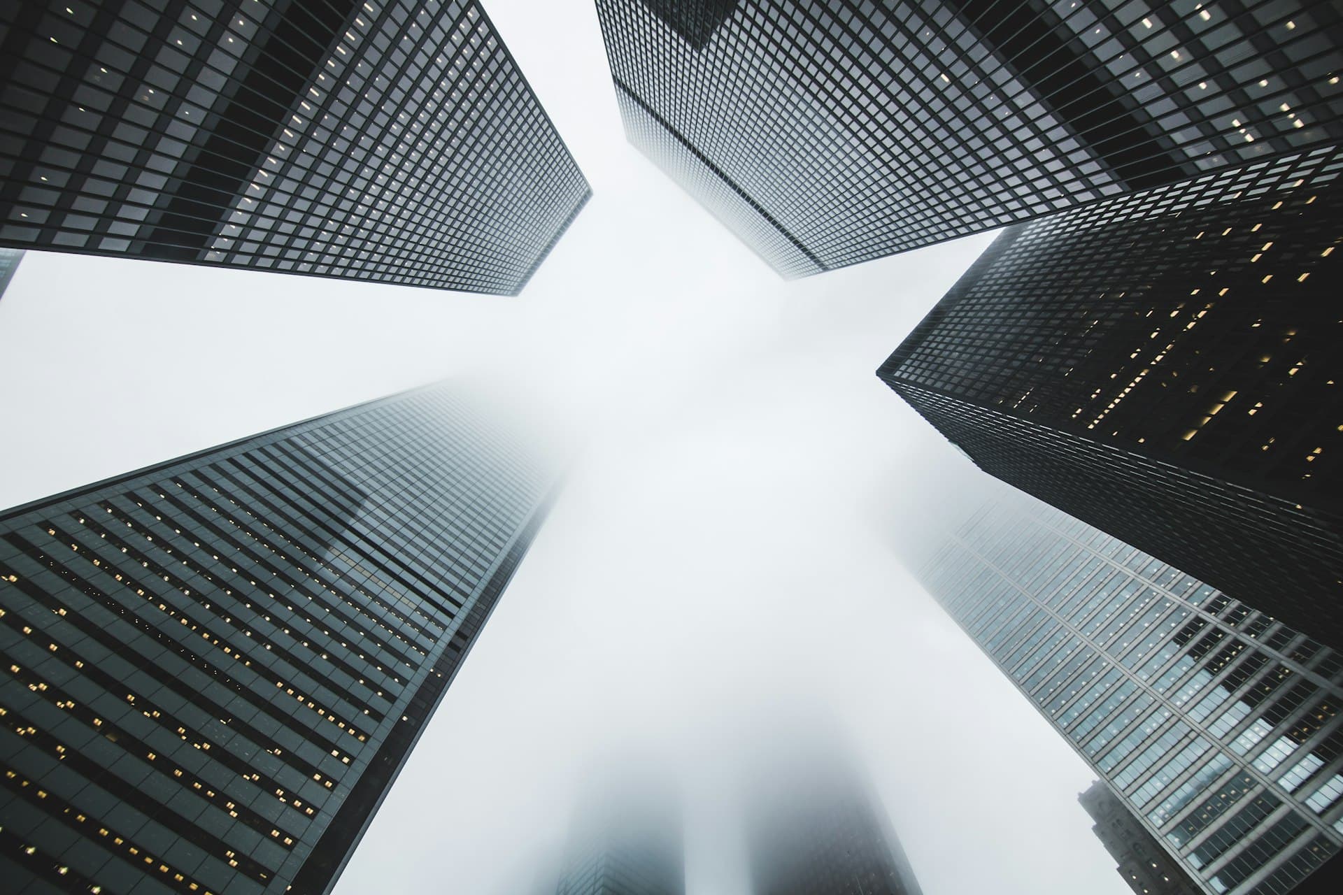 High-rise structures disappearing into fog