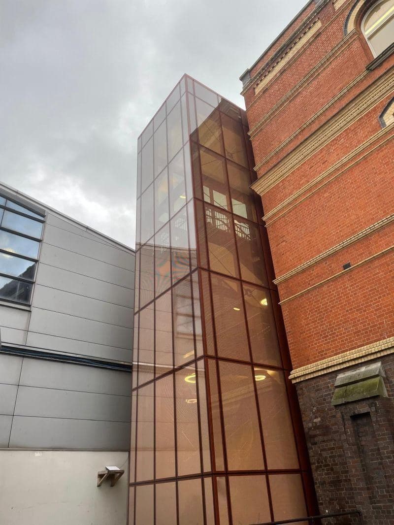 Corten-clad and glazed station annex, envelope meeting the structural frame
